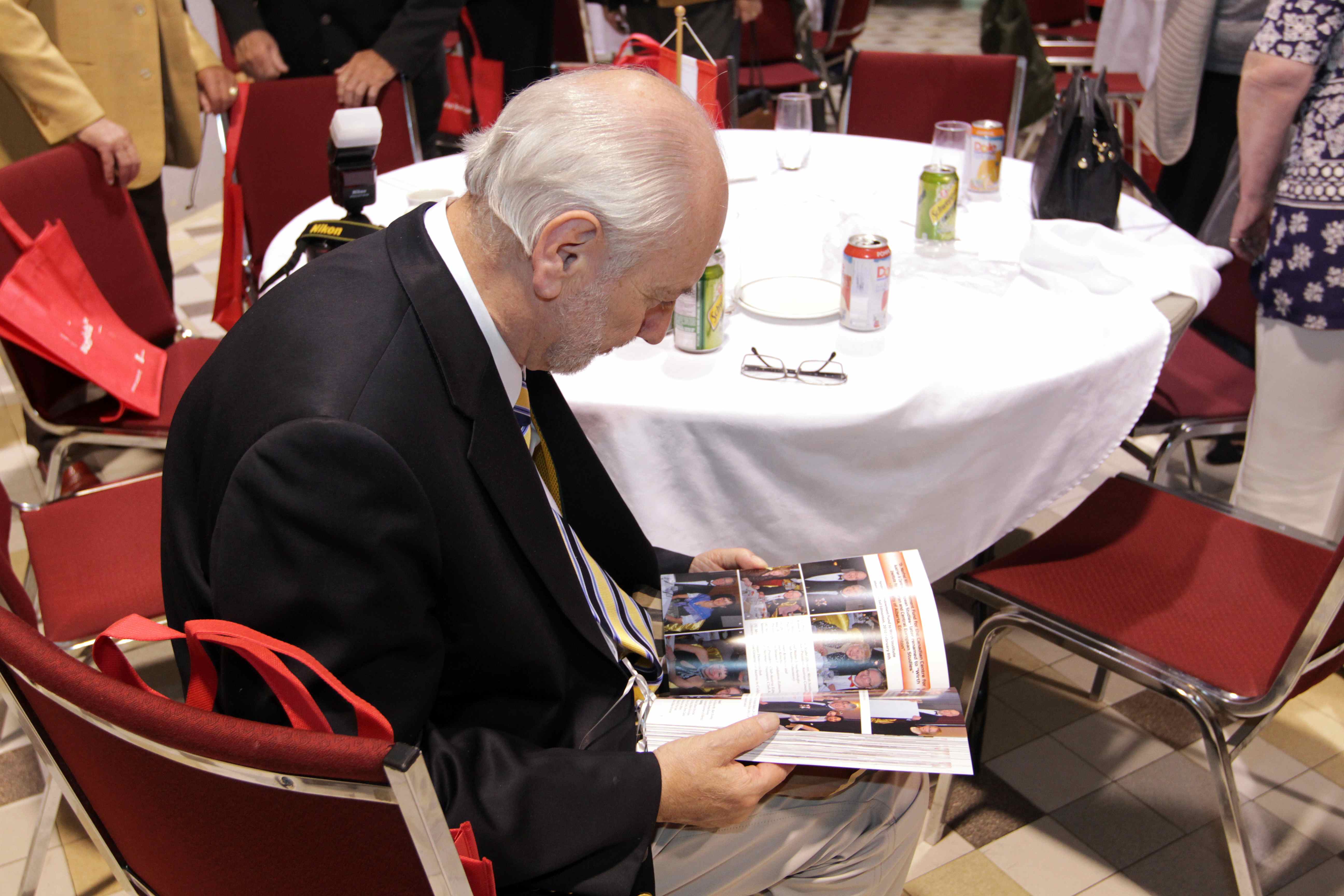 Dr. Szabo leafs through the Anniversary Book